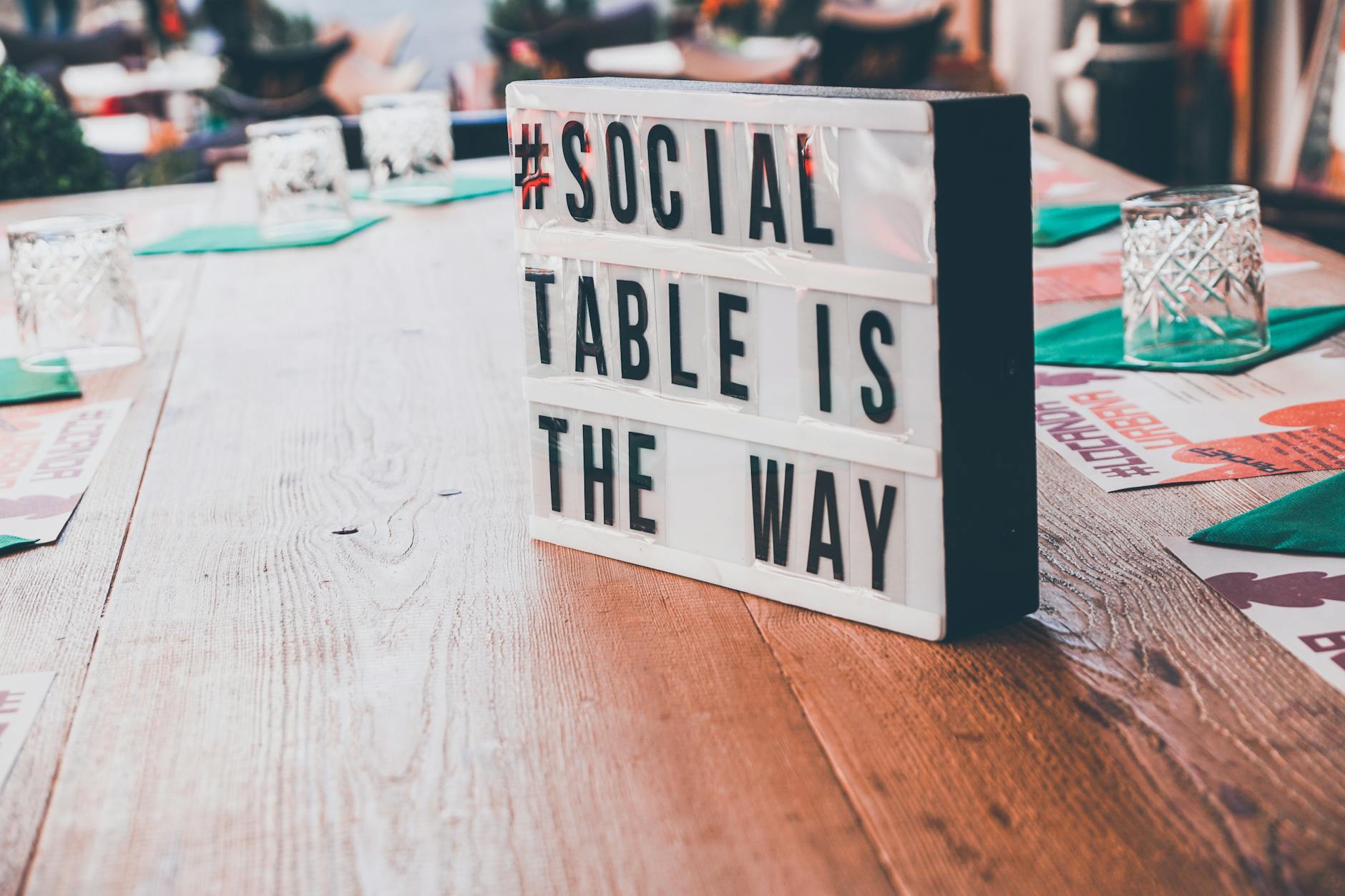 white and black signage on top of a wooden table