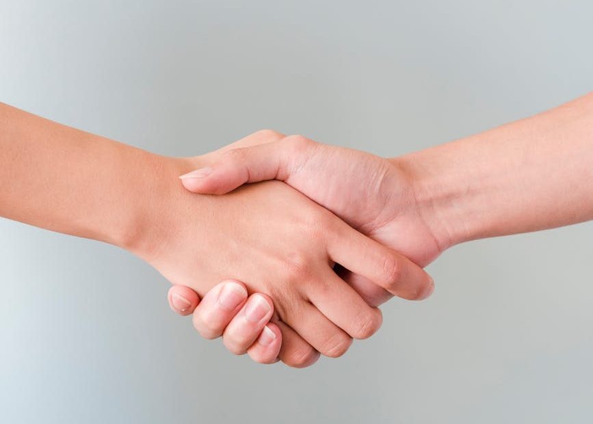 photo of people shaking hands
